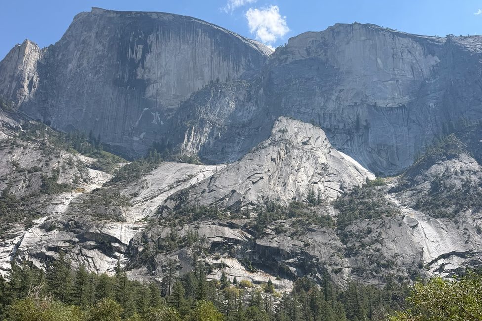 Granite walls and the shoulder of Half Dome above the treeline in Yosemite Valley
